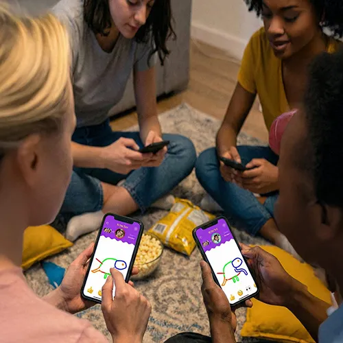 Friends drawing on their phones together in Imposter Artist